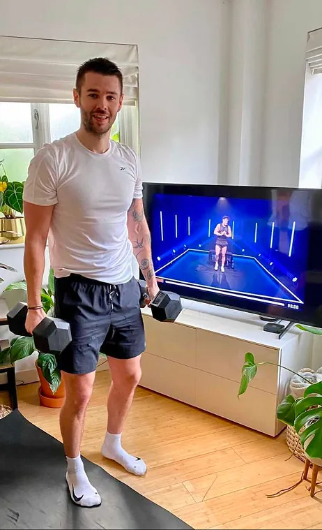 Member training with dumbbells at home